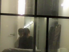 neighbor films couple through window