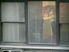 Topless neighbor girl in a window peep